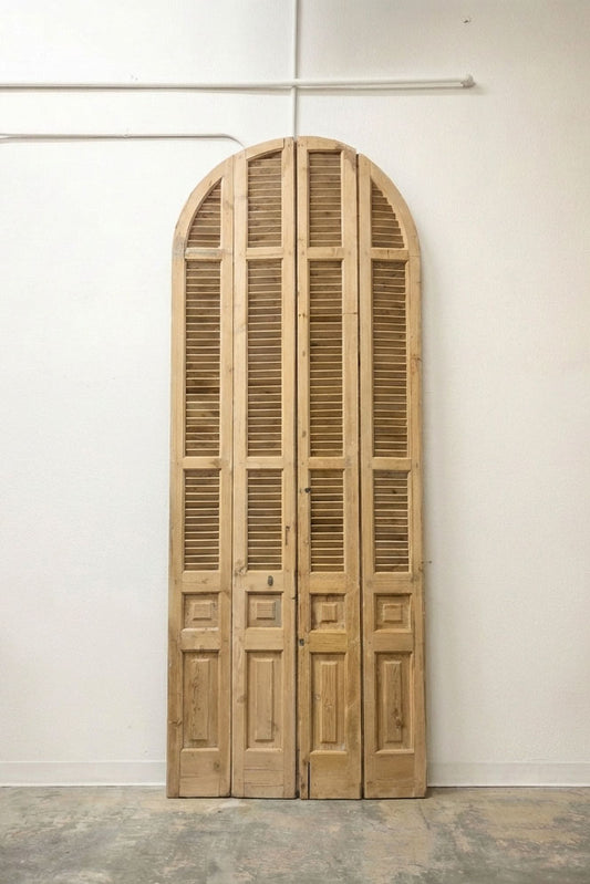 Grand arched louvered double doors in natural blonde pine, four-panel set