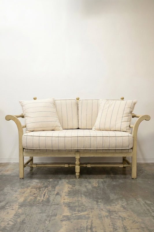 French country loveseat with striped cream linen upholstery and painted ivory wood frame