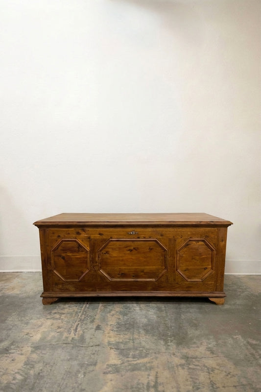 Antique pine blanket chest with three octagonal carved front panels and bracket feet