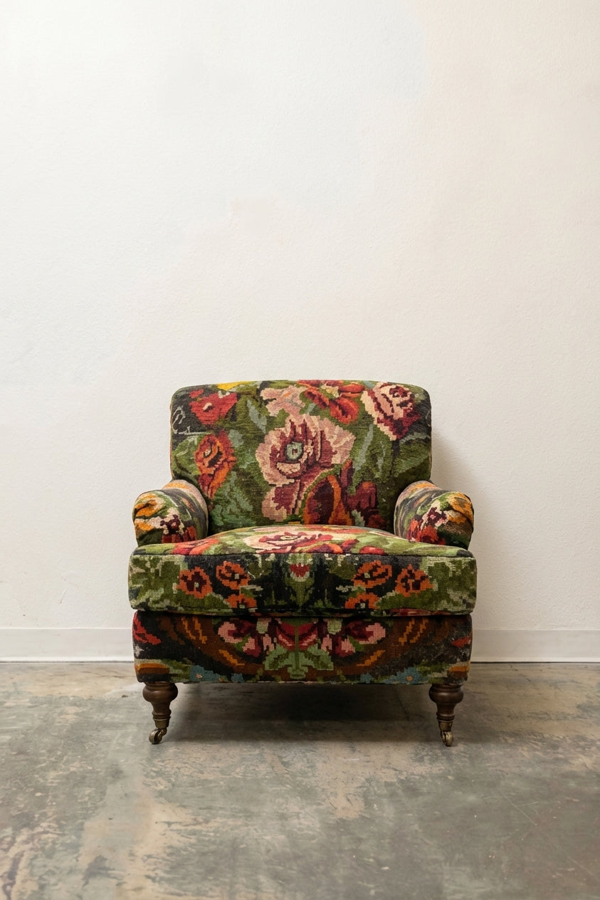 Victorian armchair in bold multicolor floral tapestry with turned legs and brass casters